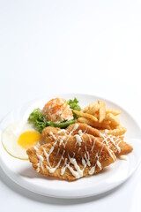 deep fried golden crispy fish fillet and chips with fried egg, French fries, coleslaw salad in tartar sauce western cuisine menu