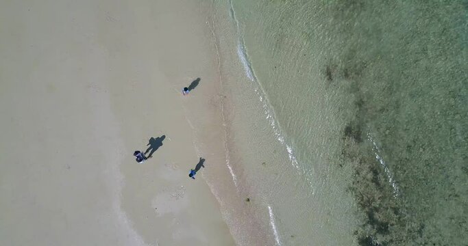 Aerial shot of Children playing on the beach 