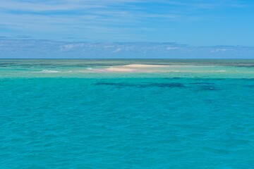 Naklejka na ściany i meble Sand cay in the Great Barrier Reef surrounded by crystal clear water