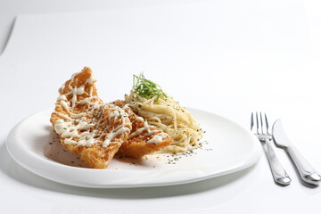 deep fried golden crispy fish fillet in tartar sauce with carbonara pasta noodle western seafood cuisine menu