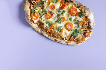 Fresh oval pizza on a colored background, top view, space for text. Pinsa's home cooking. Pizza...