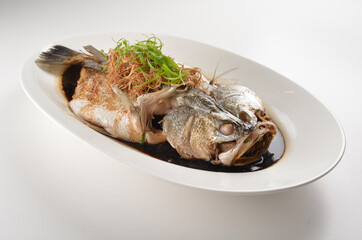hong kong style steamed whole fresh grouper fish in soya salted sauce and ginger and garlic onion seafood asian menu
