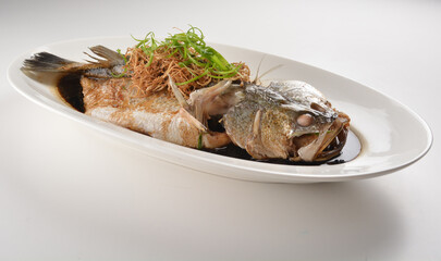 hong kong style steamed whole fresh grouper fish in soya salted sauce and ginger and garlic onion seafood asian menu