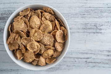 Whole grain glazed flakes in plate. Healthy breakfast, whole grain muesli in a bowl