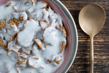 Whole grain glazed flakes with yogurt in plate. Healthy breakfast, whole grain muesli in a bowl