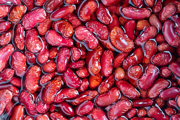 Red beans pattern as background in water, close up