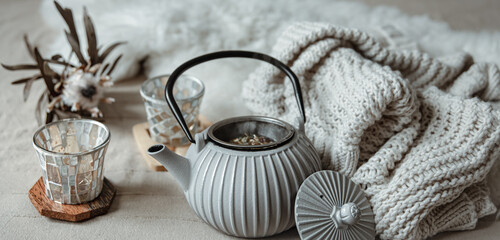 Cozy home composition with teapot and home decor details.