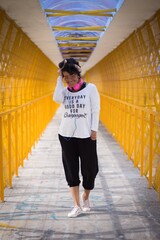 Portrait of a mid adult afro mexican smiling woman walking and looking down