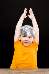 a beautiful red-haired boy with a homemade foil hat