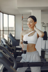 A beautiful girl in a gym on a racetrack