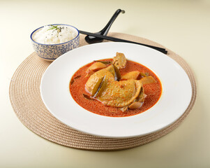 local red nyonya peranakan Malay spicy curry chicken gravy with steam white rice in bowl on white table restaurant asian cafe halal chinese banquet menu