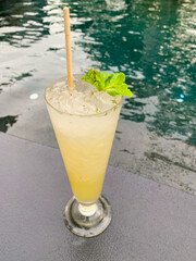 lemon juice mojito cocktail put over resort pool.