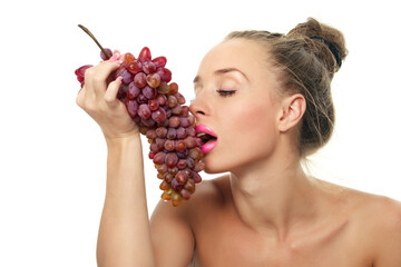 Woman holding a bunch of red grapes