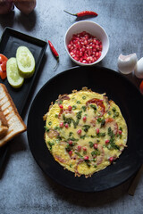 Wholesome breakfast food items frittata served with condiments along with condiments. Top view.