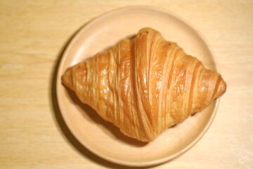 delicious croissant on a wood plate at the kitchen