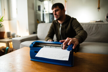 Blind man typing on typewriter with braille code