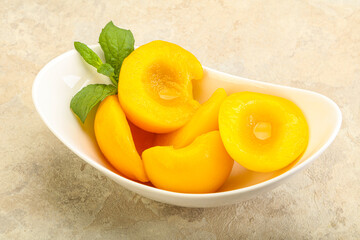 Sweet ripe canned peaches with mint
