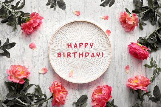 Text Happy Birthday. Red Pink Peony Flowers On Shabby Chic White Background, Flat Lay On Cracked White Washed Wood And Decorative Round Tray. Simple, Minimal Greeting Design For Poster, Banner, Card.