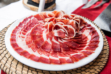 Plate of acorn-fed Iberian ham on the table at an event