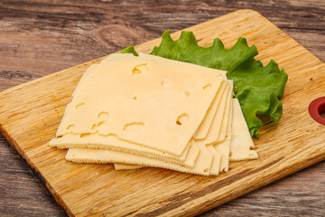 Sliced yellow cheese over board