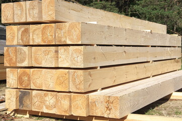 the beams are stacked. sawing logs into boards. construction of a house from a bar.