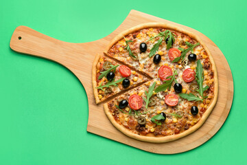 Board with tasty pizza on color background