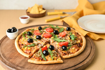 Board with tasty pizza on color background