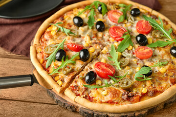 Board with tasty pizza on wooden background, closeup