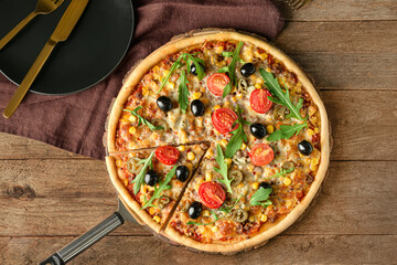Board with tasty pizza on wooden background