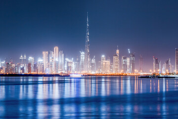 Panoramic view of the Burj Khalifa and other skyscrapers in the financial center of Dubai in the UAE with reflections in the waters of the Creek Channel