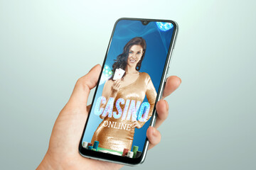 Beautiful girl with playing cards in her hand on the smartphone screen. Online casino, gambling,...