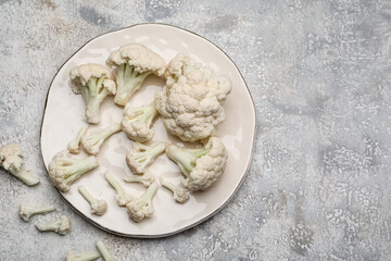 Plate with cauliflower cabbage on grunge background