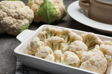 Baking dish with cauliflower cabbage on grunge background, closeup