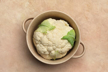 Pot with cauliflower cabbage on color background