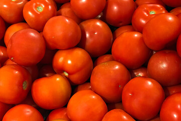 Fresh ripe tomatoes piled on the market. Food backgroumd. Harvest