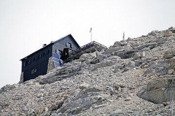 Fototapeta premium Mountain hut at the Pordoi in the Sella group in the Dolomiltes, a mountain range in northeastern Italy