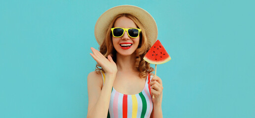 Summer portrait of happy smiling young woman with lollipop or ice cream shaped slice of watermelon...