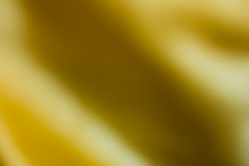 Close up of blurred image of yellow wavy textile. For using as background and wallpaper.