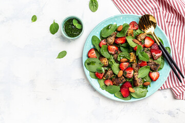 Ketogenic, keto diet. Salad with strawberries, spinach, chicken liver, almond and mint. Healthy food. Keto paleo diet menu, banner, recipe place for text, top view