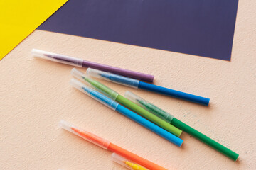 A set for children's creativity and development. felt-tip pens, colored paper on the table.