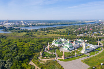 Aerial view of Staro-Golutvin monastery and Shchurovsky cement plant Holcim at sunny day. Kolomna, Moscow Oblast, Russia.