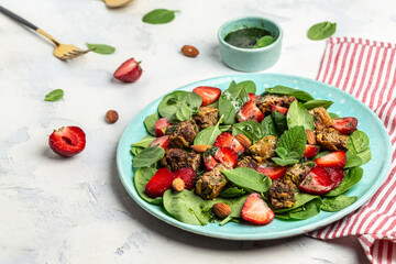 Fresh salad with chicken liver, spinach, strawberries, almond and mint. Healthy food, ketogenic diet, diet lunch concept. Keto paleo diet menu, top view