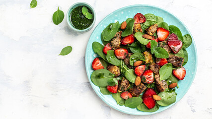 Spinach salad with strawberries, chicken liver, almond and mint. Healthy balanced food. Top view, above, banner