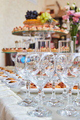 Buffet at the event. An assortment of snacks on a white plate. Banquet service, restaurant on the road. Food, snacks with meat, ham, ham, bread and tomatoes, seafood snacks
