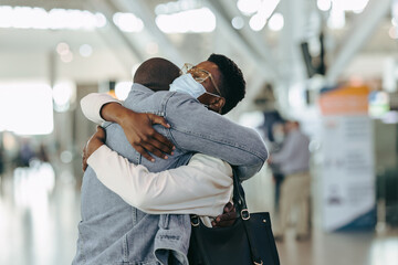 African couple reunion at airport after covid-19 lockdown