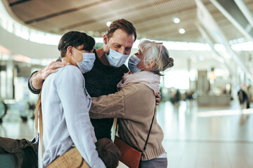 Senior woman receiving her family at airport after flight arrival