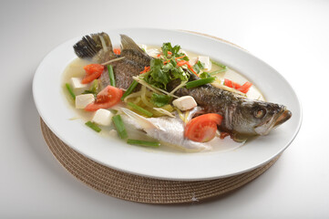 steamed fresh whole grouper fish with beancurd, tomato, sour vegetable and ginger in teo chew style asian halal menu