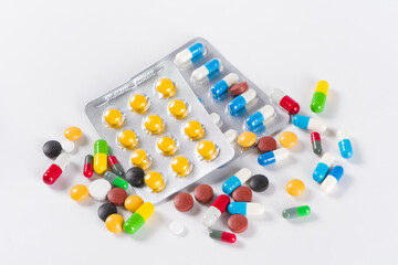 Assorted pharmaceutical medicine pills, tablets and capsules on white background