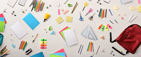 Assortment of school supplies on white table top view