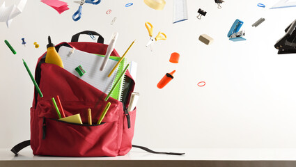 School supplies flying and coming out of school backpack
